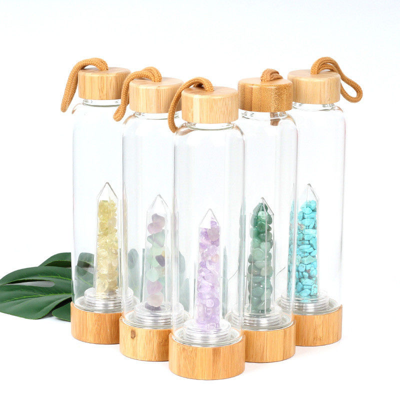 Round Glass Water Bottle With Natural Crystal Gemstone Center Elixir Crystal Point supplier